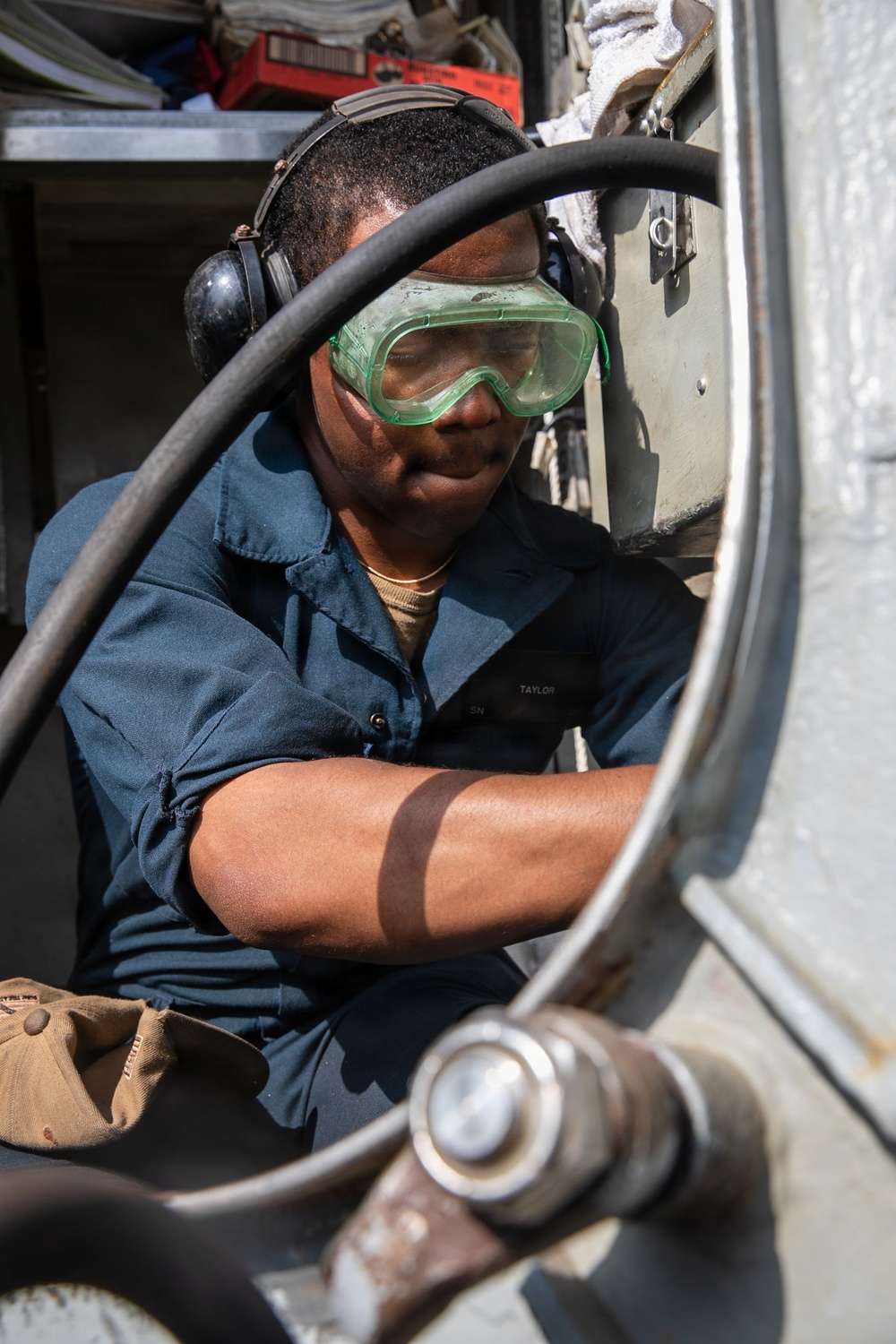 USS Mitscher (DDG 57) Sailor conducts deck preservation