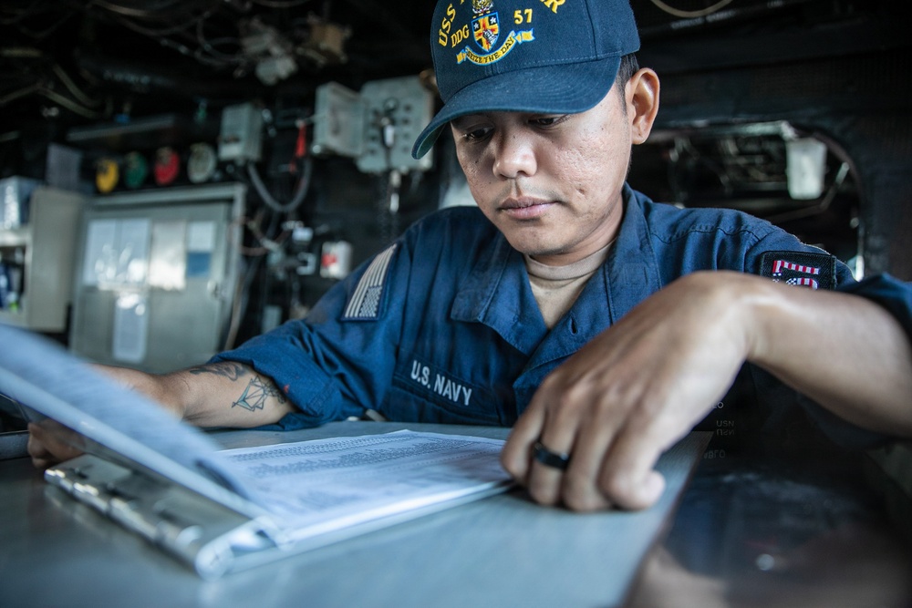 USS Mitscher (DDG 57) Sailor stands watch in ship bridge
