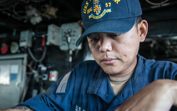 USS Mitscher (DDG 57) Sailor stands watch in ship bridge