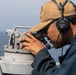 USS Mitscher (DDG 57) Sailor stands watch on bridge wing