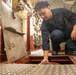 USS Mitscher (DDG 57) Sailor inspects valve in main machinery room