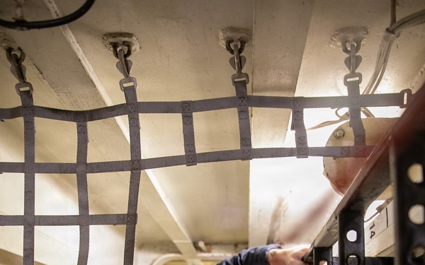 USS Mitscher (DDG 57) Sailor inspects safety net