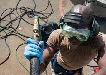 USS Mitscher (DDG 57) Sailor uses needle gun