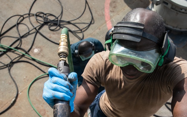 USS Mitscher (DDG 57) Sailor uses needle gun