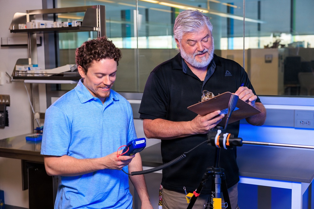 Industrial hygiene field service employees conduct study to measure fume hood safety for laboratory workers