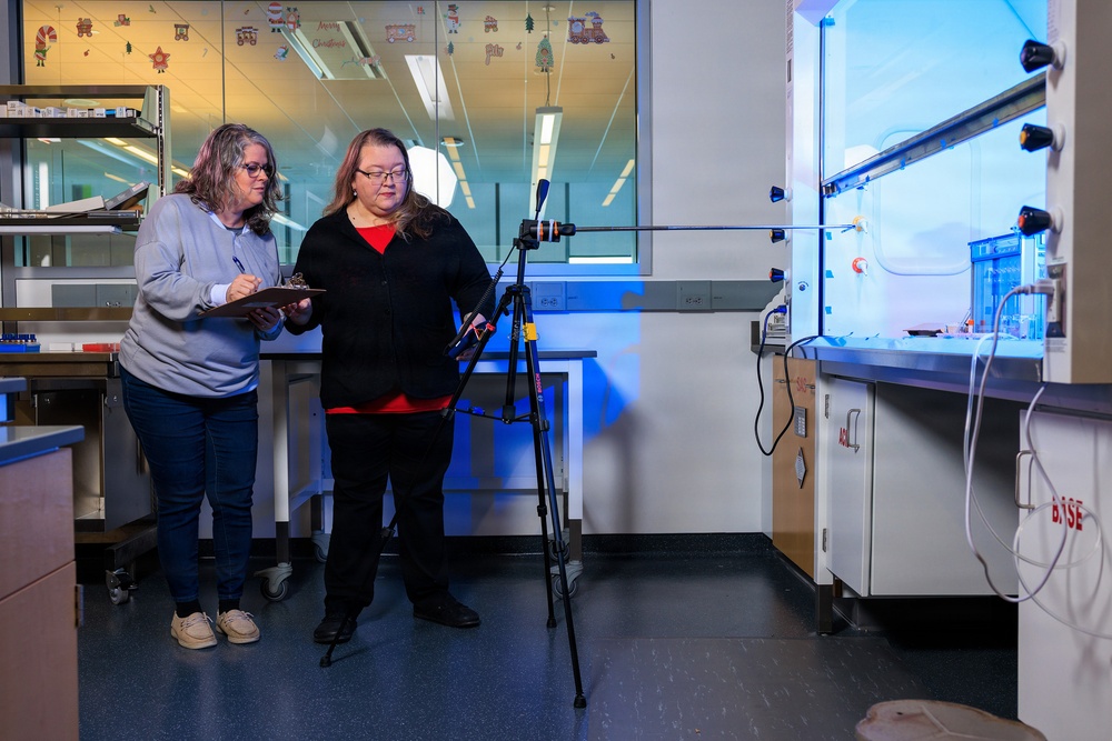 Industrial hygiene field service employees conduct study to measure fume hood safety for laboratory workers