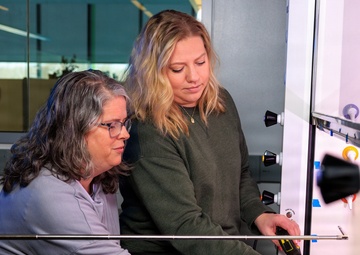 Industrial hygiene field service employees conduct study to measure fume hood safety for laboratory workers