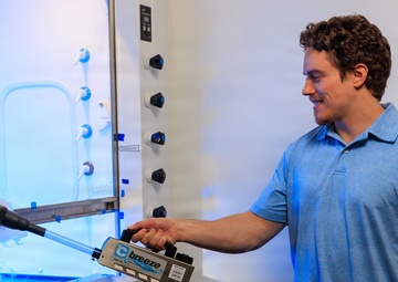 Industrial hygiene field service employees conduct study to measure fume hood safety for laboratory workers