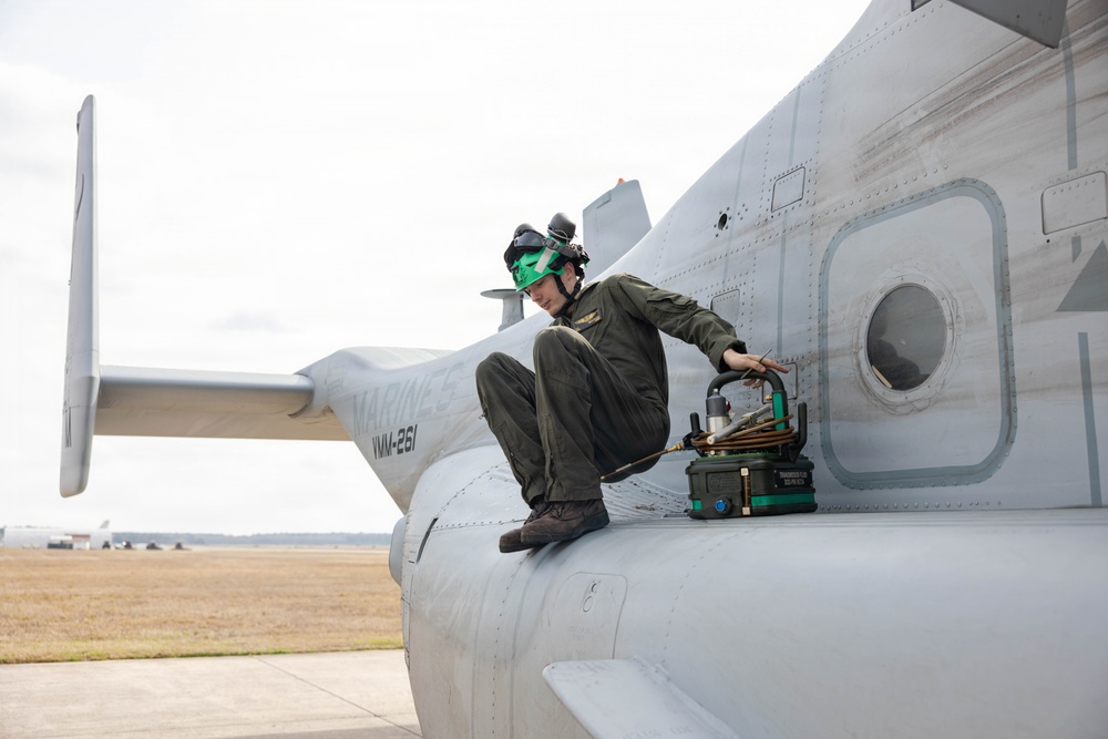 U.S. Marines with VMM-261 conduct maintenance on an MV-22B Osprey