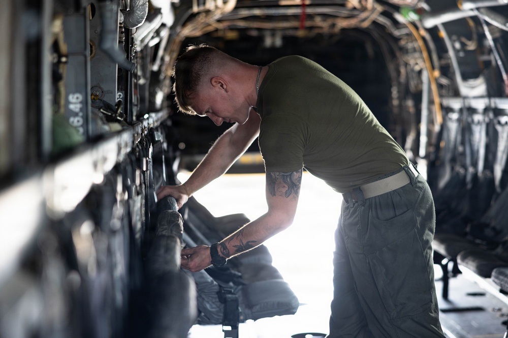 U.S. Marines with VMM-261 conduct maintenance on an MV-22B Osprey