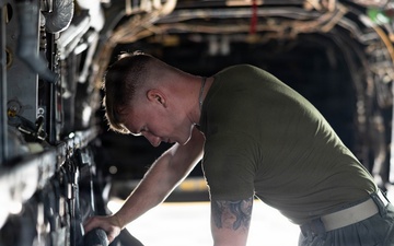U.S. Marines with VMM-261 conduct maintenance on an MV-22B Osprey