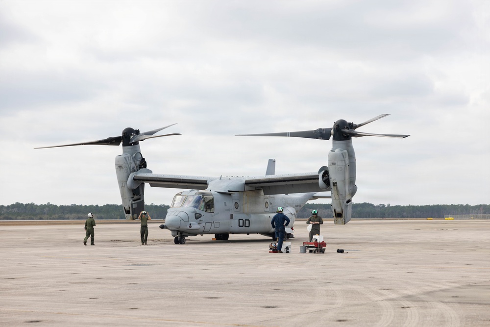U.S. Marines with VMM-261 conduct maintenance on an MV-22B Osprey