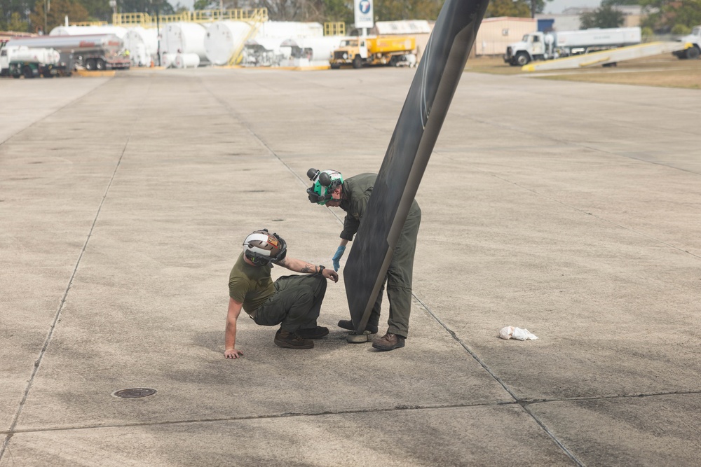 U.S. Marines with VMM-261 conduct maintenance on an MV-22B Osprey