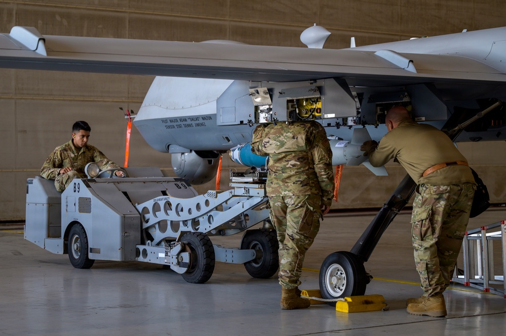 174th Attack Wing Airmen load GBU-38 munitions onto MQ-9 during Sentry South 26-2