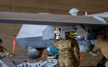 174th Attack Wing Airmen load GBU-38 munitions onto MQ-9 during Sentry South 26-2