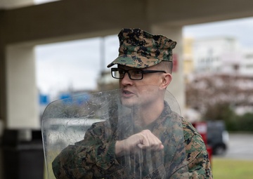 Marines partake in a riot control exercise at Camp Foster