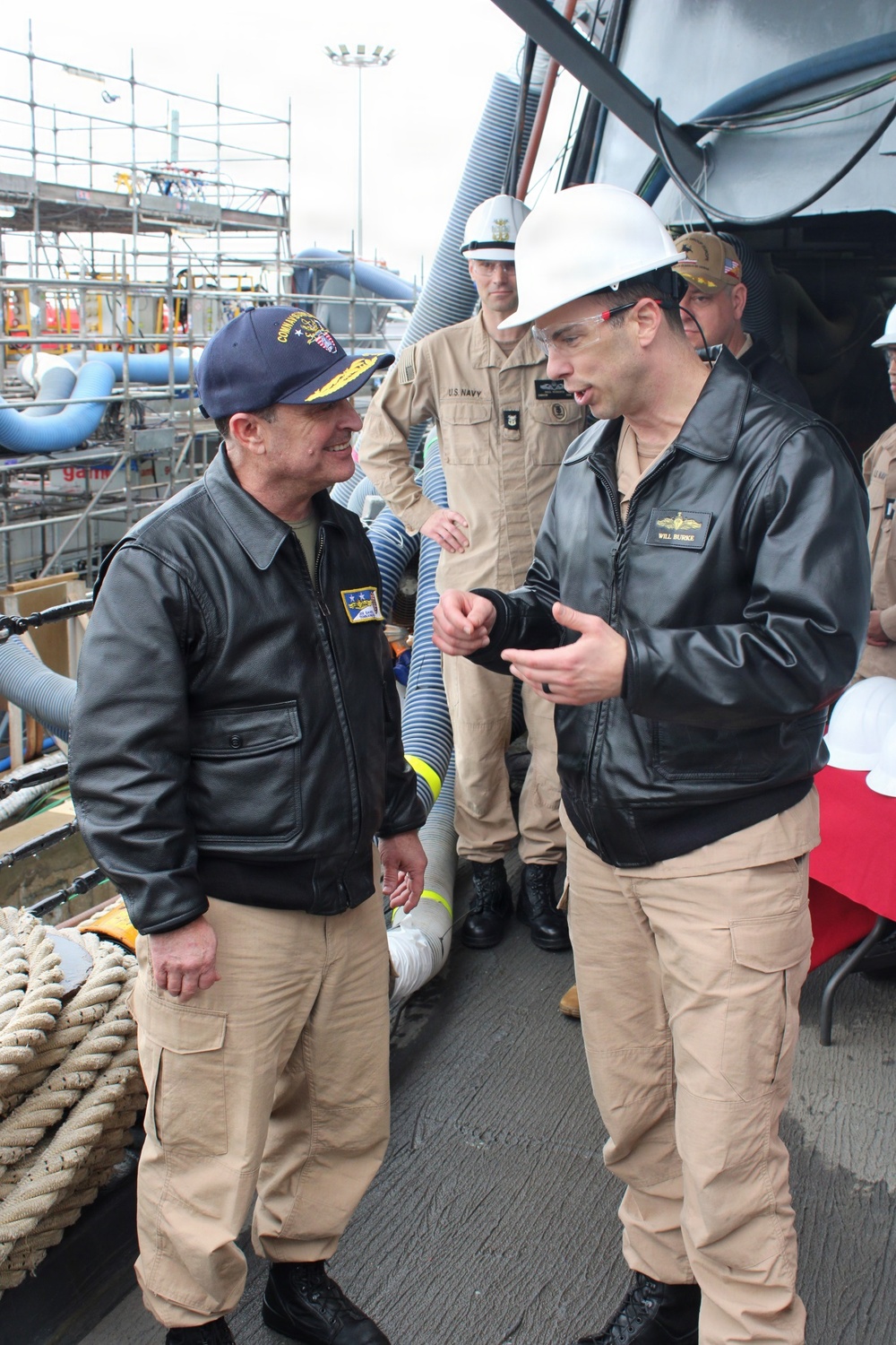 Rear Adm. Joe Cahill speaks with Cdr. William Burke, commanding officer of Arleigh Burke-class guided-missile destroyer USS Paul Ignatius (DDG 117)
