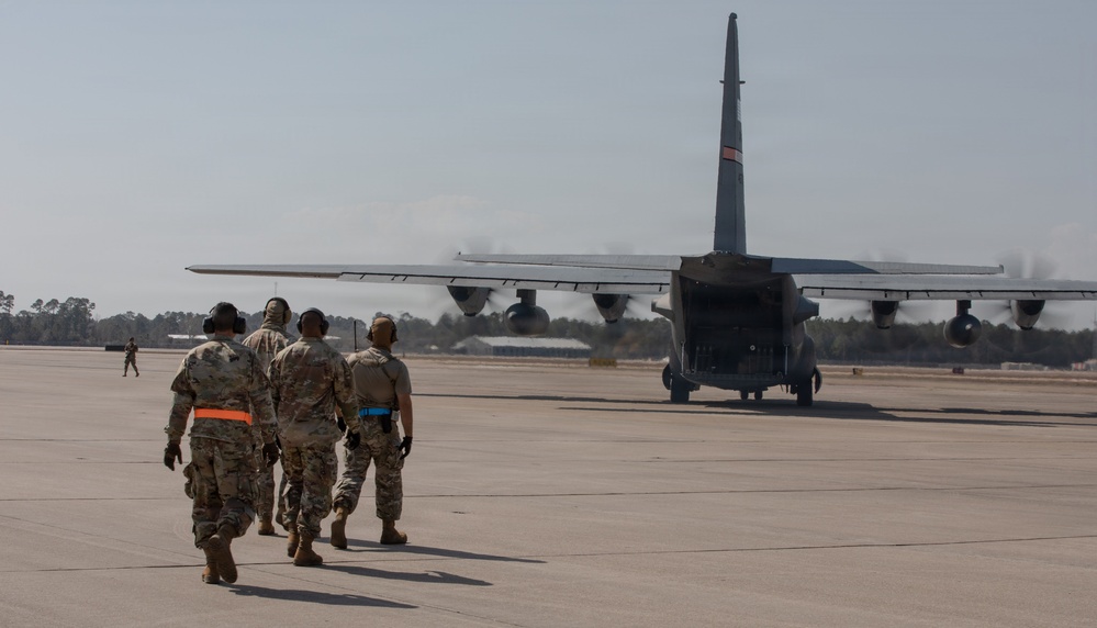 Airmen Approaching C-130 for Cargo Drop