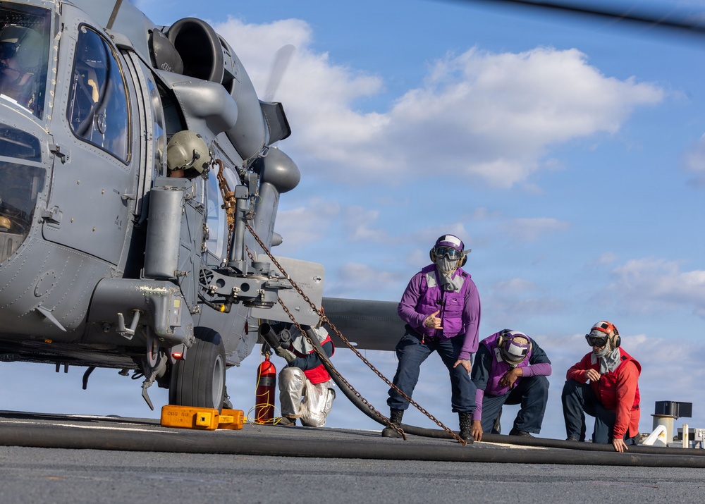 USS Milius (DDG 69) refuels 33rd Rescue Squadron helicopter