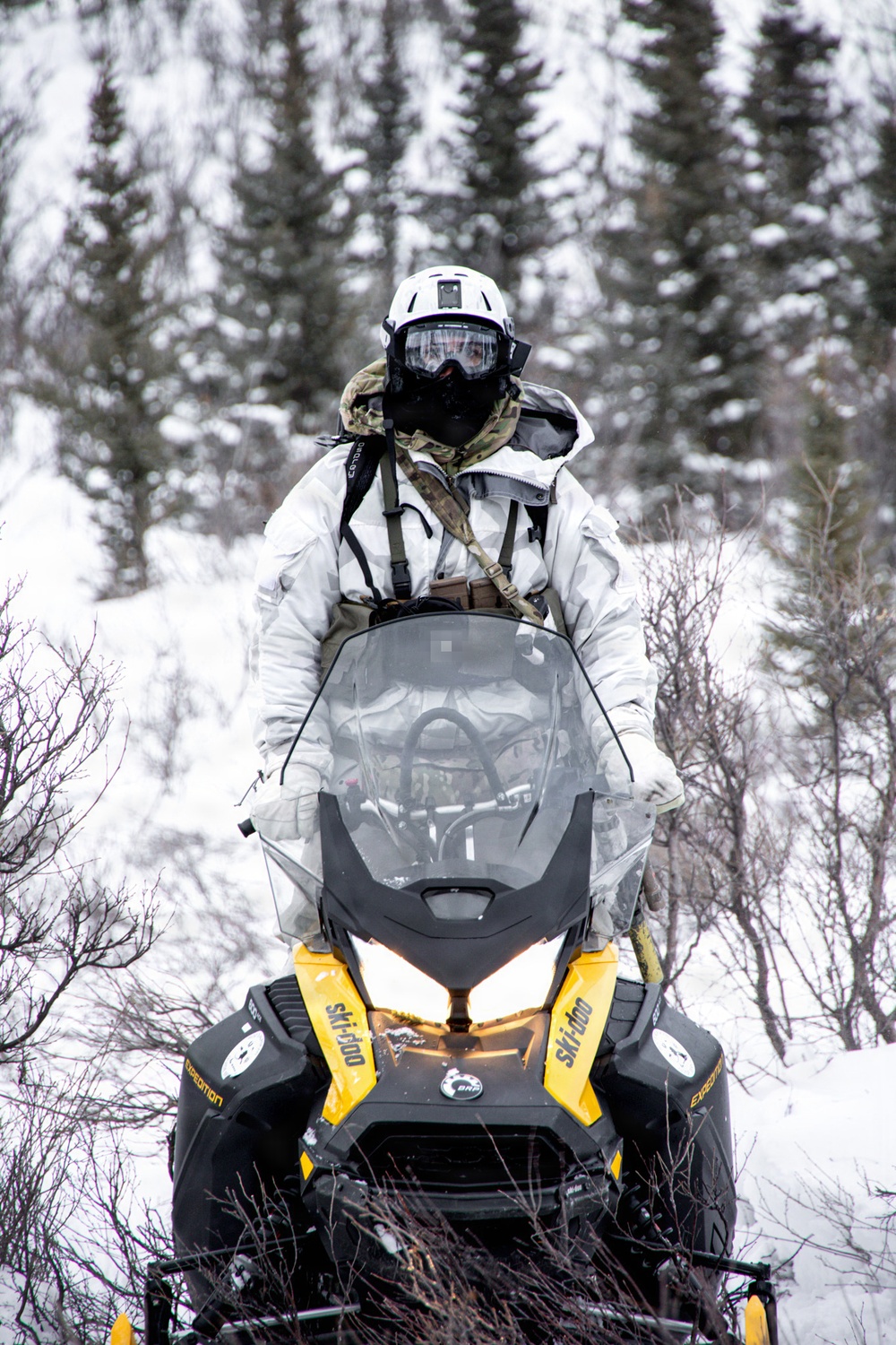 Green Beret operates snowmobile through Alaskan wilderness