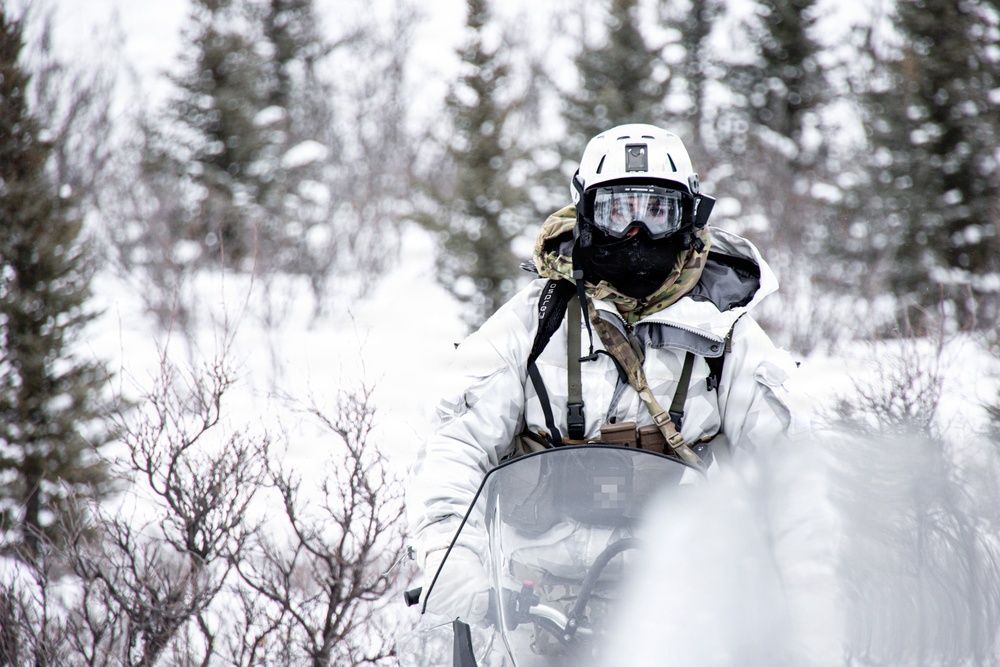 Green Beret drives snowmobile toward reconnaissance site