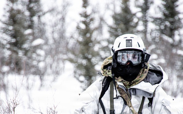 Green Beret drives snowmobile toward reconnaissance site