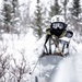 Green Beret drives snowmobile toward reconnaissance site