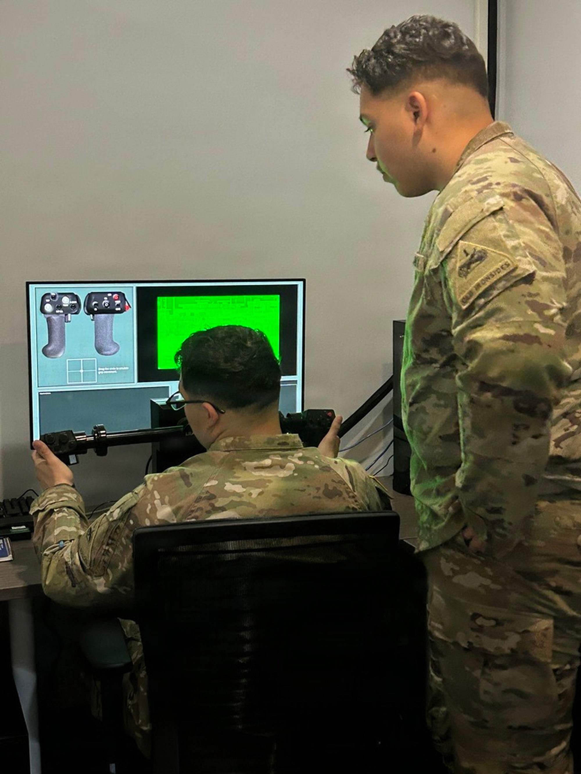 Soldiers in the touch point familiarized themselves on the legacy Long Range Advanced Scout Surveillance System (LRAS3) hand grips prior to interacting with various Future Advanced Long-range Common Optical/Netted-fires Sensors (FALCONS) prototypes. (U.S. Army photo by Lein Ma) (Photo Credit: Michael Bortot)