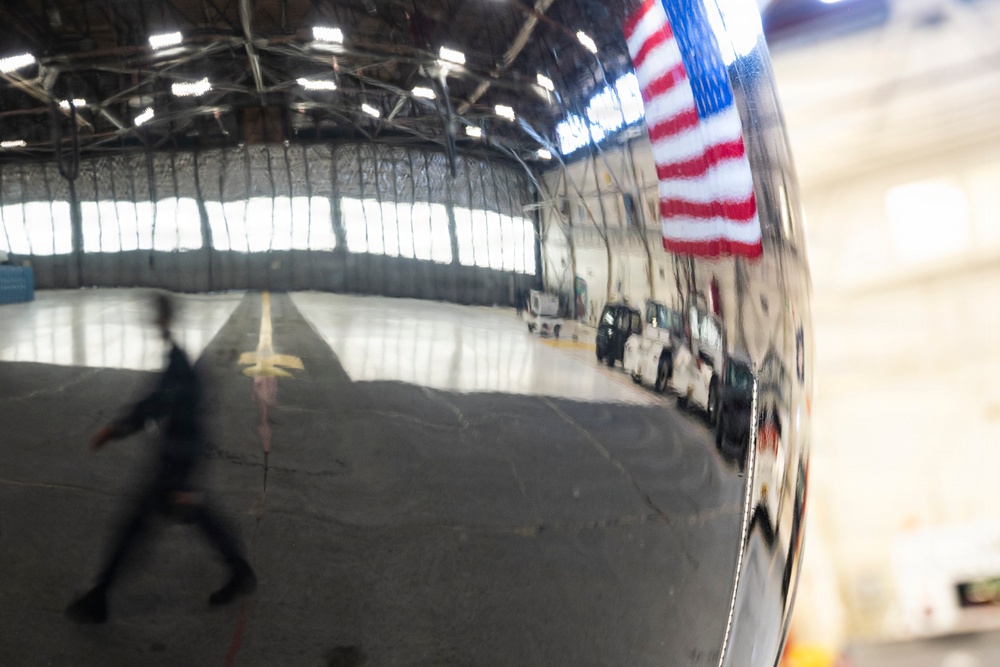 Joint Force medical experimentation team tour aircraft hangar at USCG Air Station Kodiak during ARCTIC EDGE 2026