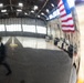 Joint Force medical experimentation team tour aircraft hangar at USCG Air Station Kodiak during ARCTIC EDGE 2026