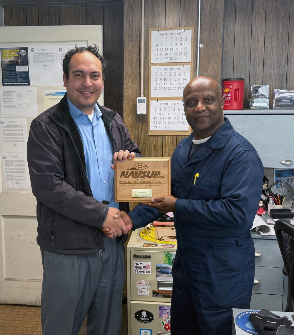 Jesse Denton receives his COQ award