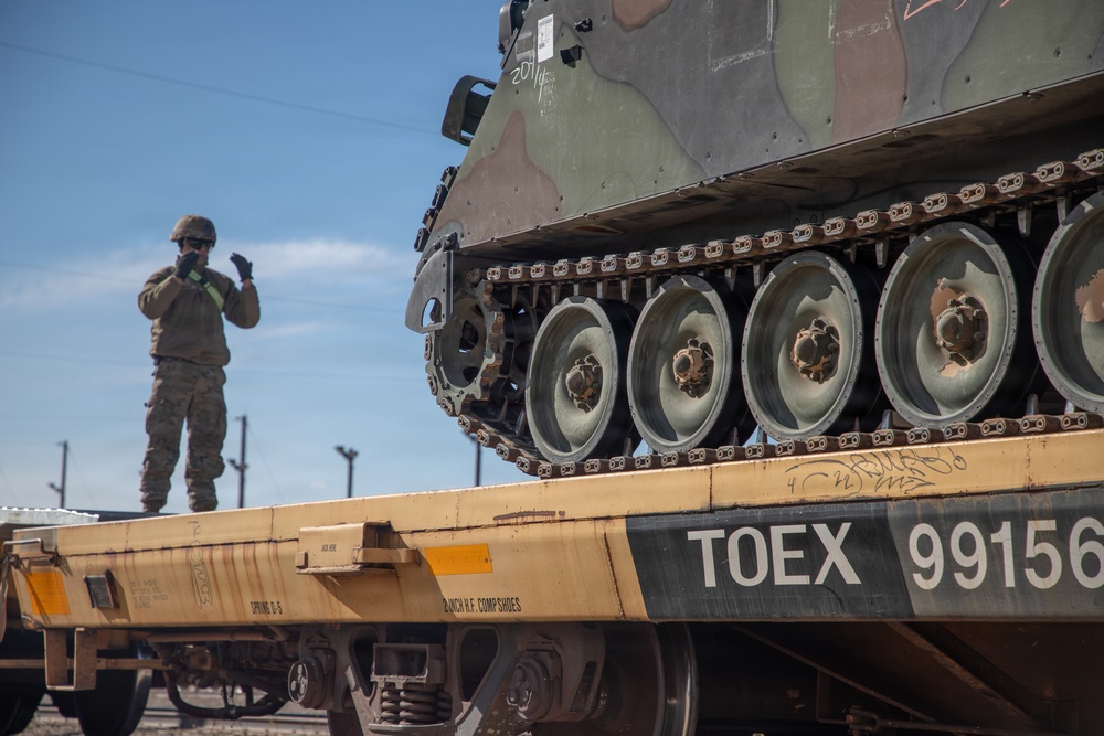 Rolling out: Iron Soldiers load armored power onto the rails