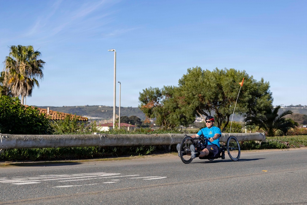 Sailors and Coast Guardsmen ride adaptive bicycles during timed trials