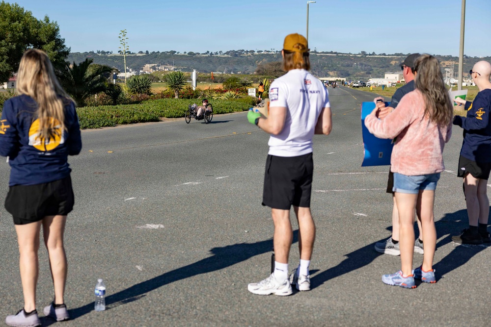 Sailors and Coast Guardsmen ride adaptive bicycles during timed trials