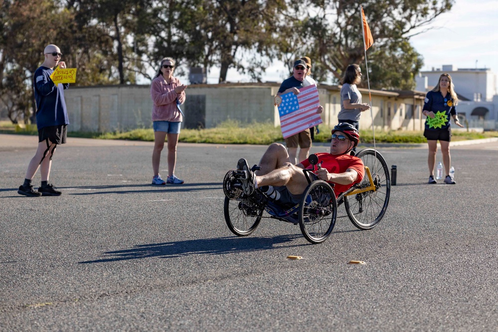 Sailors and Coast Guardsmen ride adaptive bicycles during timed trials
