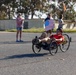 Sailors and Coast Guardsmen ride adaptive bicycles during timed trials