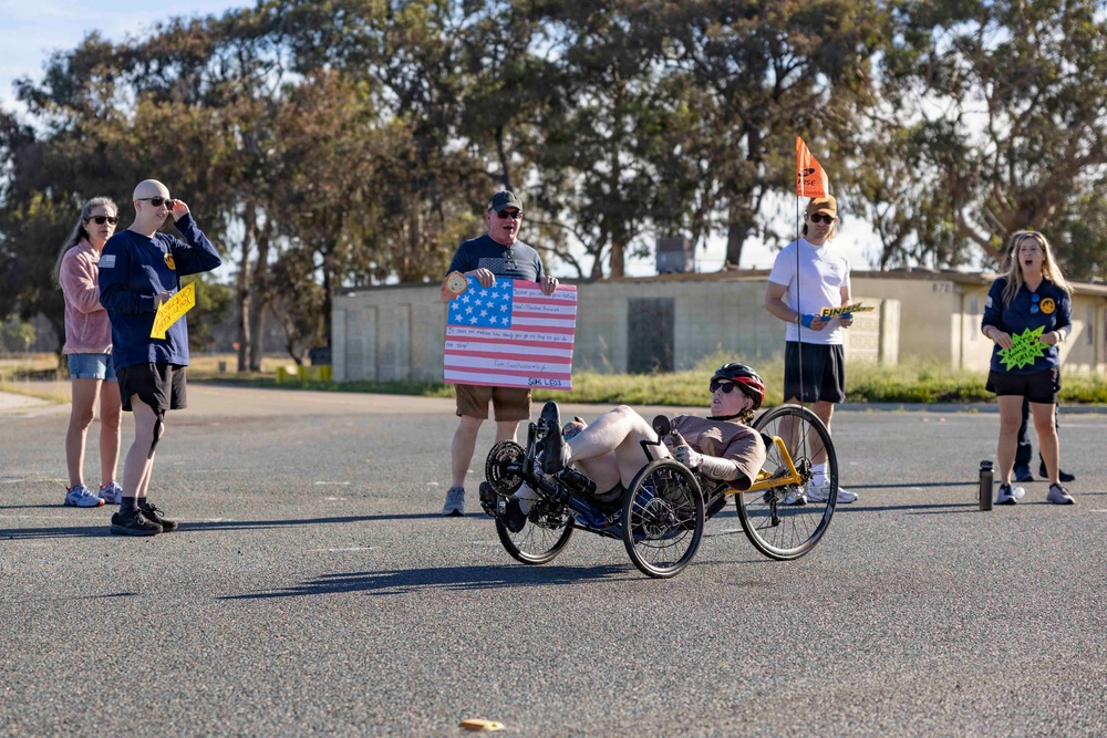 Sailors and Coast Guardsmen ride adaptive bicycles during timed trials