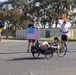 Sailors and Coast Guardsmen ride adaptive bicycles during timed trials