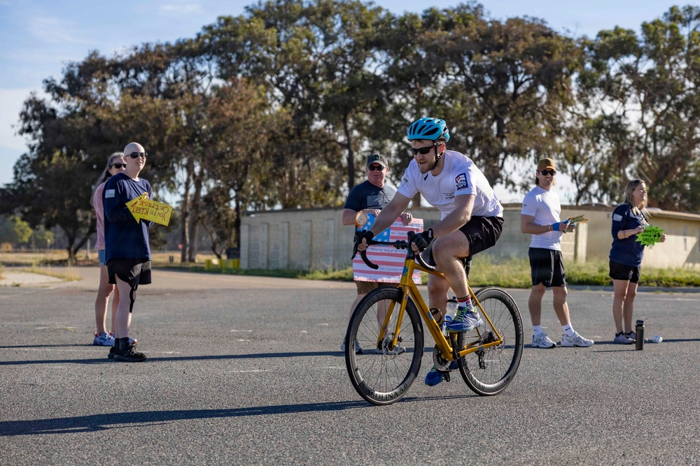 Sailors and Coast Guardsmen ride adaptive bicycles during timed trials