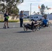 Sailors and Coast Guardsmen ride adaptive bicycles during timed trials