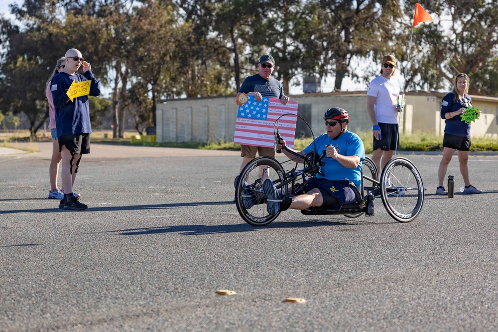 Sailors and Coast Guardsmen ride adaptive bicycles during timed trials