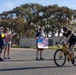 Sailors and Coast Guardsmen ride adaptive bicycles during timed trials