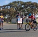 Sailors and Coast Guardsmen ride adaptive bicycles during timed trials