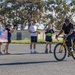 Sailors and Coast Guardsmen ride adaptive bicycles during timed trials