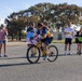Sailors and Coast Guardsmen ride adaptive bicycles during timed trials