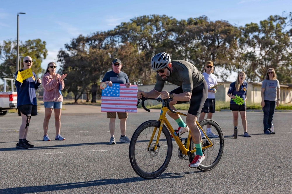 Sailors and Coast Guardsmen ride adaptive bicycles during timed trials