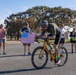 Sailors and Coast Guardsmen ride adaptive bicycles during timed trials