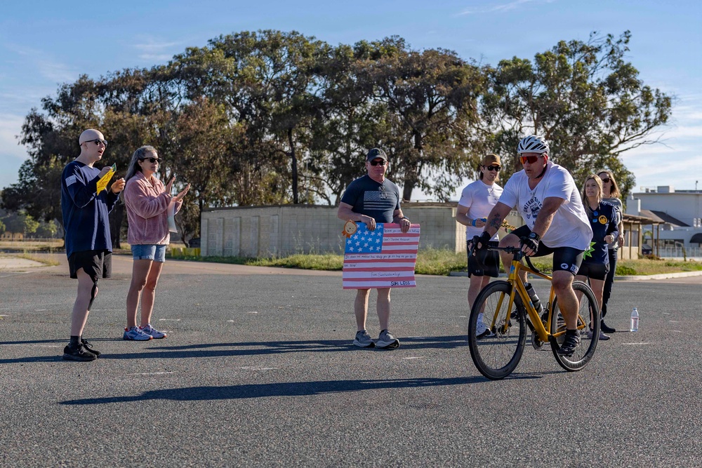 Sailors and Coast Guardsmen ride adaptive bicycles during timed trials