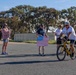 Sailors and Coast Guardsmen ride adaptive bicycles during timed trials