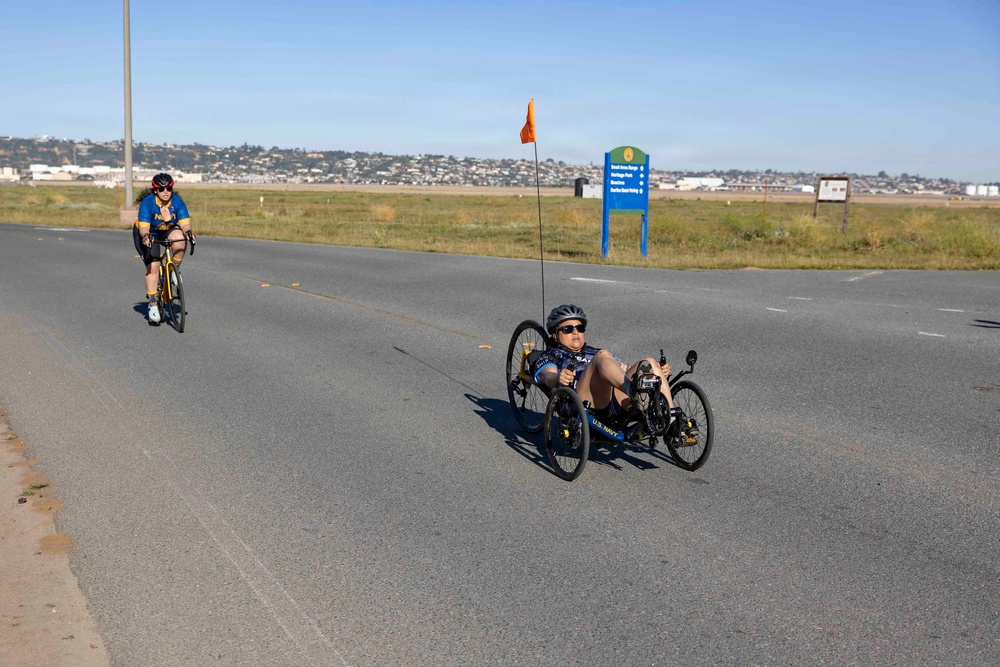 Sailors and Coast Guardsmen ride adaptive bicycles during timed trials
